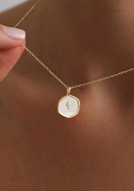 Petite enamel cross necklace in gold, shown close up