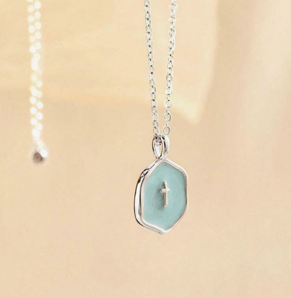 Ice blue enamel cross pendant on a silver chain